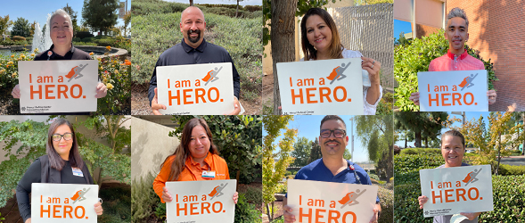 HERO Ambassadors holding a sign that reads I am a hero