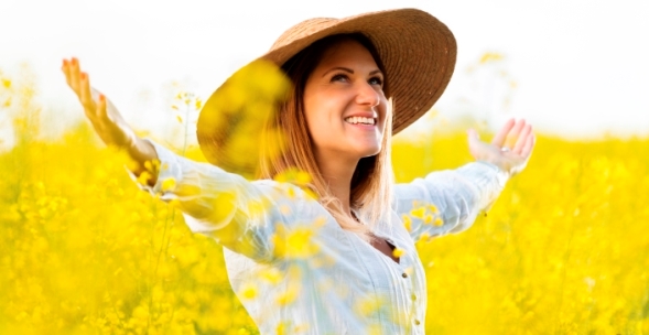 Woman in a field of yellow flowers