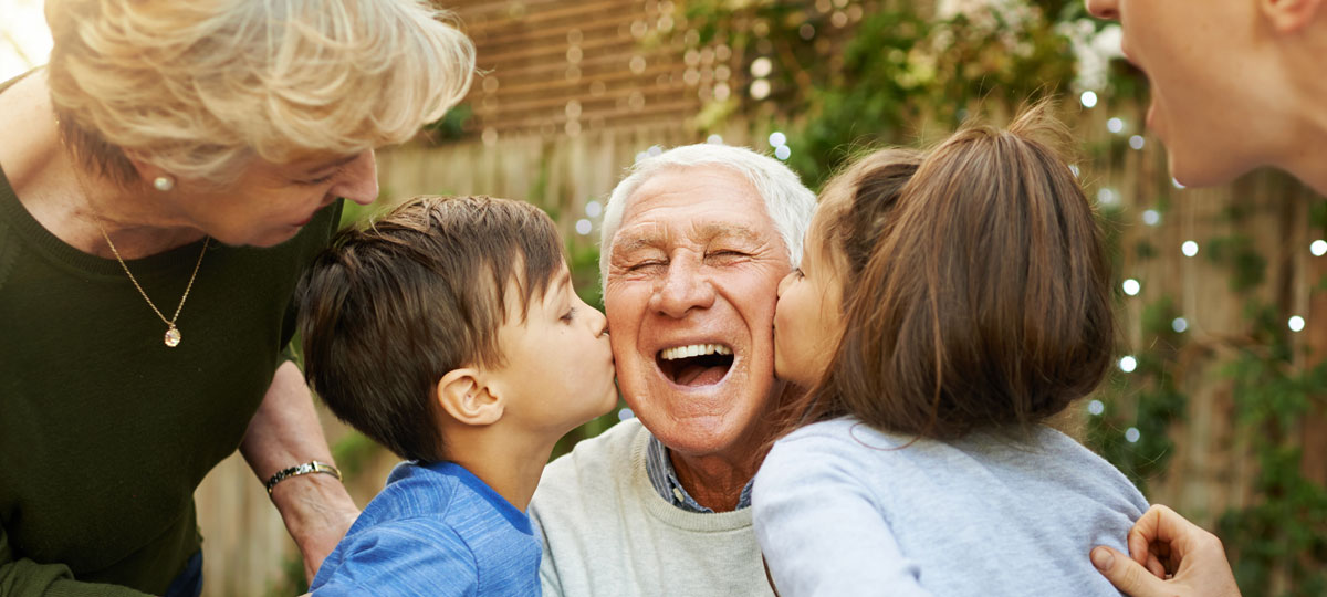 grandpa getting kissed by grandkids